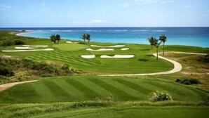 A golf course with a view of the ocean.