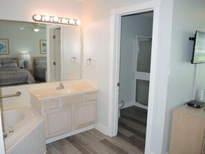 A bathroom with a vanity, sink, and mirror. - 503 2 Bedroom Villa by RedAwning (Calabash)