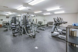 A gym with various exercise machines, a mirrored wall, and a clean, well-lit environment. - MainStay Suites Columbus near Fort Benning (Columbus)