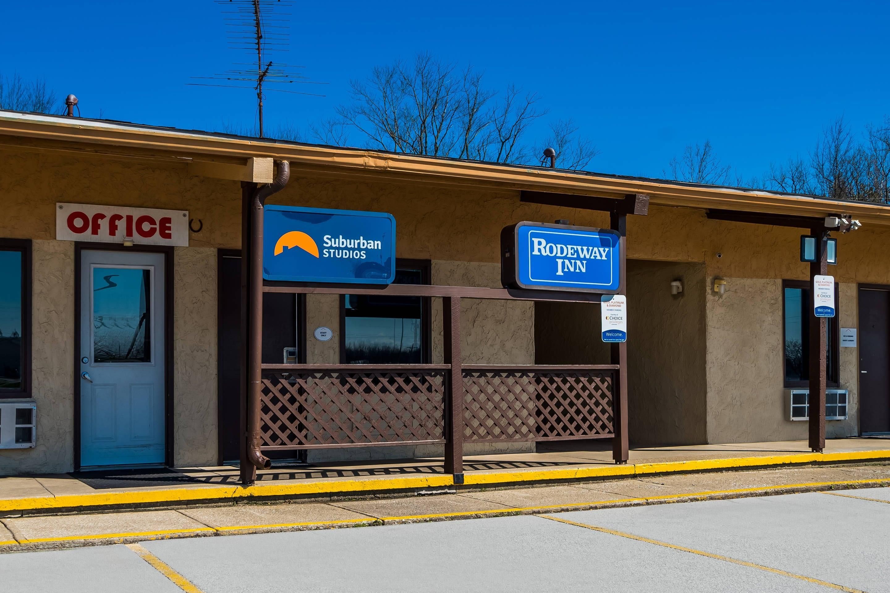 Ein Gebäude mit Schildern für 'Suburban Studios' und 'Rodeway Inn', das ein Motel oder Hotel kennzeichnet.