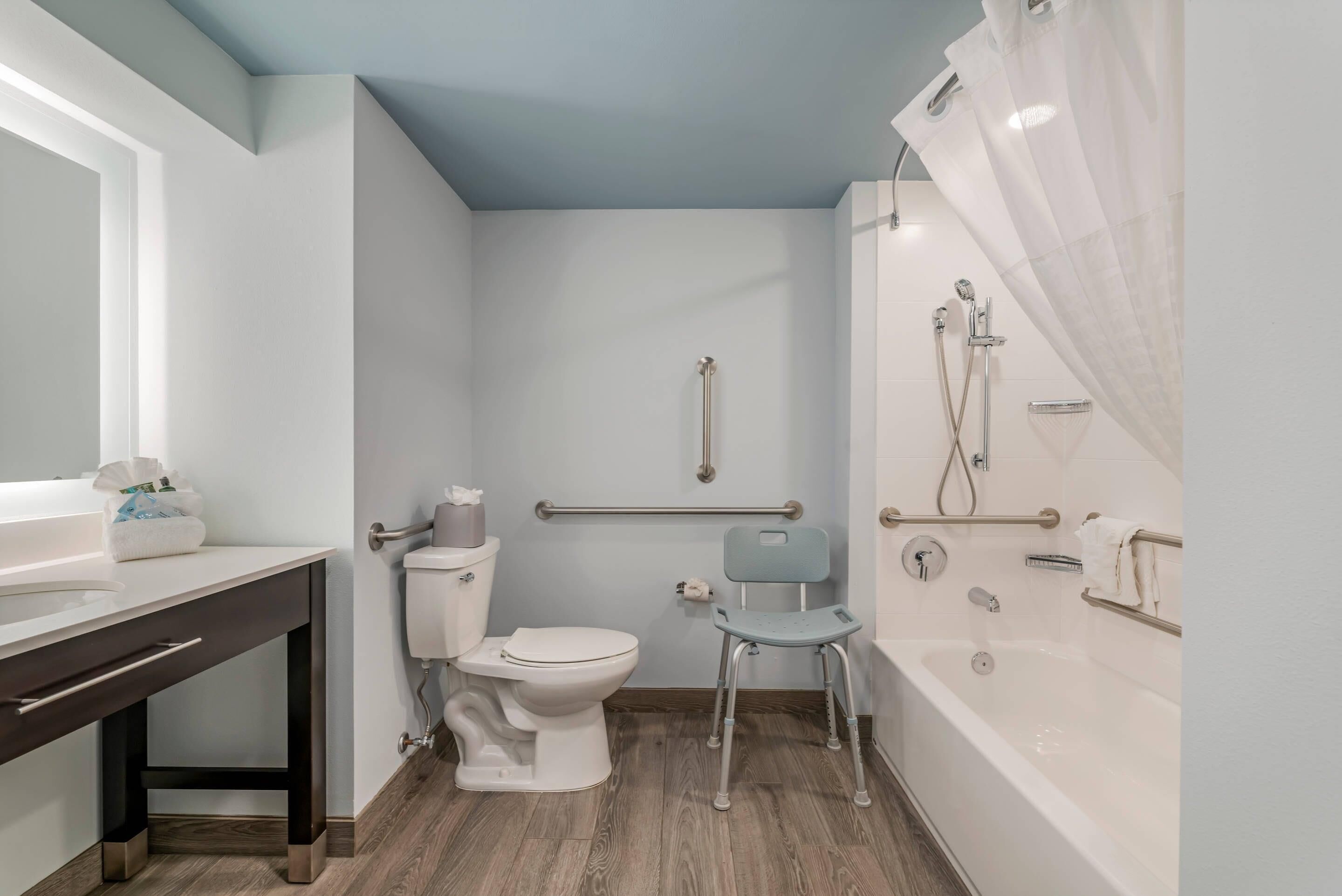 A modern bathroom with a toilet, bidet, and bathtub.