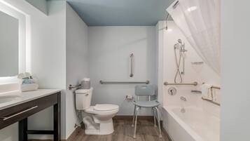 A modern bathroom with a toilet, bidet, and bathtub.
