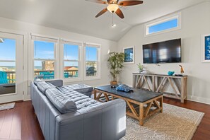 Relax in this spacious living room with a large sofa, coffee table, and flat-screen TV.