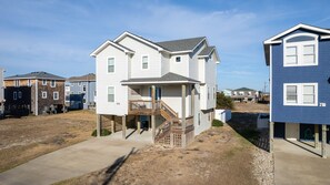 Stroll up to the entrance of this charming home, where a front porch and staircase invite you to step inside.