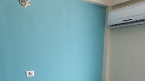 A room with two black chairs, a white table, a blue wall, and a tiled floor. - Best location (Dahab)