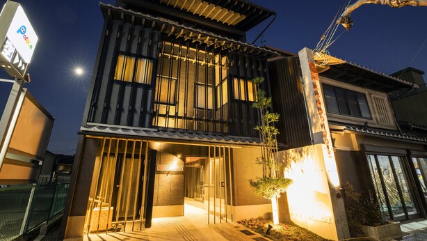 A two-story building with a traditional Japanese architectural style, featuring a wooden facade and a modern entrance with glass doors. - HALE Kyoto Toji (Kyoto)