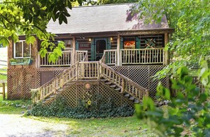 Traditional home with a charming porch and garden.