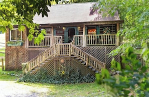Traditional home with a charming porch and garden.