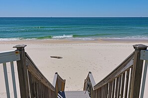 A wooden staircase leading to a beach with a clear view of the ocean. - Cute Bungalow w/small pool!
Absolutely Beach Front! (Gulf Shores)