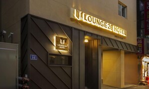 The exterior of Lounge 26 Hotel with a modern design, featuring a prominent illuminated sign and a geometric facade. - Busan Lounge 26 Hotel (Busan)