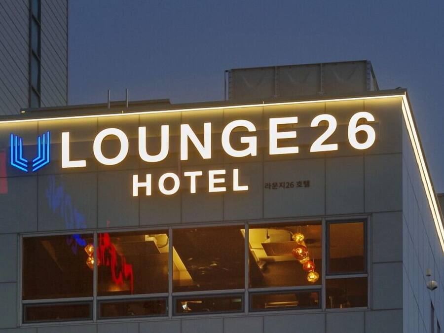 A hotel sign with the name "Lounge26 Hotel" and a logo.