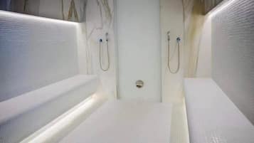 Shower and two bathtubs in a minimalist bathroom.