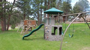 A playground with a slide, swings, and a climbing structure.
