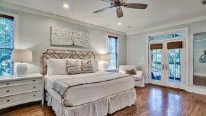 A bedroom with a large bed, a nightstand, a chair, and a ceiling fan. - 2 Minutes to Beach Club. Screened-in Porches, Bikes, Grill. Best Location! (Santa Rosa Beach)