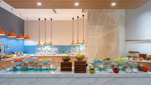 A buffet area with various food items and a modern kitchen in the background. - Holiday Inn Express Nanning Jiangnan by IHG (Nanning)