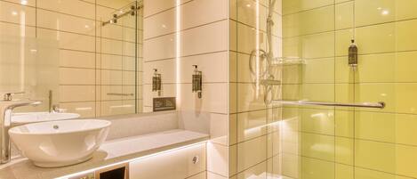 A modern bathroom with a glass-enclosed shower, a vanity with a sink, and a mirror.