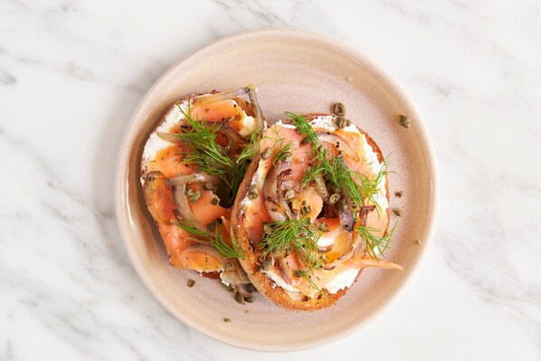 Two open-faced sandwiches on a ceramic plate.