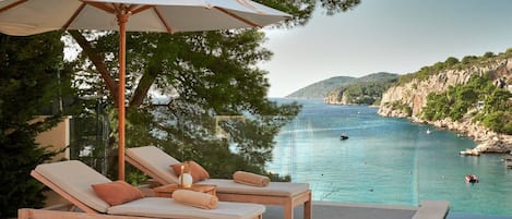 A heated pool, sun loungers