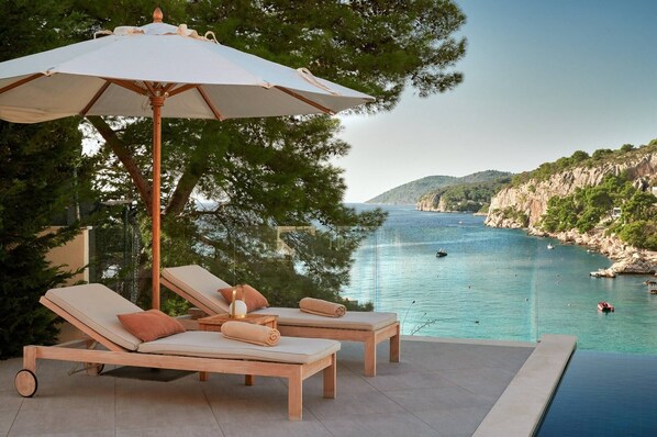 A heated pool, sun loungers