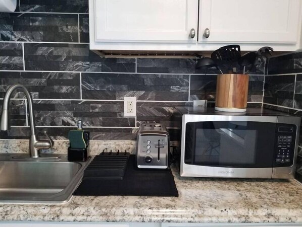 Microwave, stovetop, coffee/tea maker, cookware/dishes/utensils