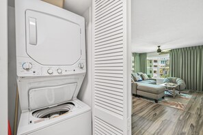 A modern laundry room with a front-loading washing machine. - Newly updated!! 2 Bed 2 Bath Beach View! (Destin)