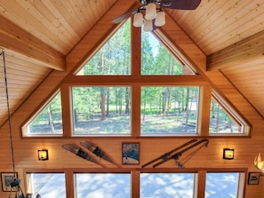 A wooden cabin with a sloped roof, large windows, and a ceiling fan. - Nordic Village Cabin in the heart of Mazama (Mazama)