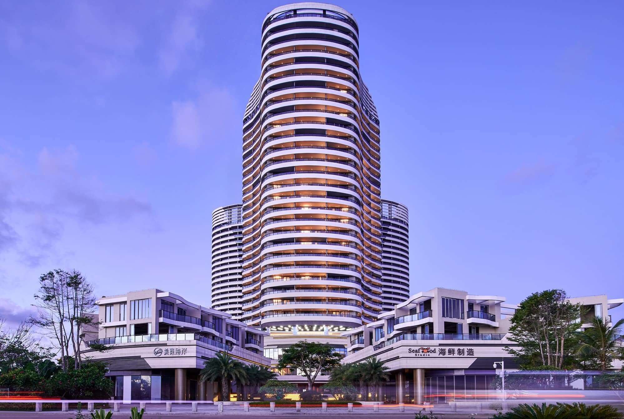 A modern high-rise building with multiple balconies, likely a hotel or residential complex.