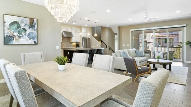 A modern kitchen with a dining area, a chandelier, and a large window. - Luxury Rental by The Princess  (Scottsdale)