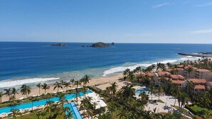 A resort with a pool, beach, and ocean views.