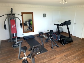 A home gym with a treadmill, stationary bike, and weight machine. - Villa Endeavour So private, breathtaking ocean views, direct from owner ! (St Barthélemy)