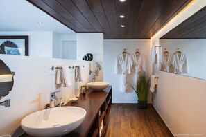 A modern bathroom with a large sink, mirror, and multiple towel hooks. - Villa Endeavour So private, breathtaking ocean views, direct from owner ! (St Barthélemy)