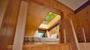 A wooden bunk bed with a skylight, a small window, and a wooden ladder. - Stunning Modern Private Cabin at River Mountain Resort (Everett)