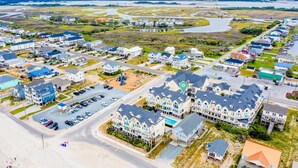 An aerial view of a coastal residential area with houses, roads, and a beach. - Ocean View, steps from sand, enjoy it all in your spacious 3-bedroom retreat (Surf City)