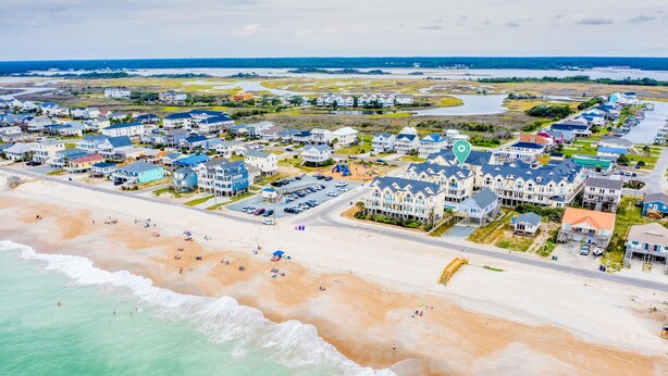 An aerial view of a coastal residential area with houses, a beach, and a water body. - Ocean View, steps from sand, enjoy it all in your spacious 3-bedroom retreat (Surf City)