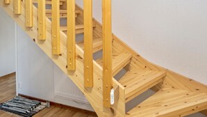 A wooden staircase with a handrail and a carpeted landing. - Iso-karpalo a by Interhome (Kuusamo)