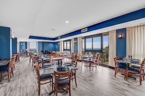 Enjoy meals in this stylish dining area with large windows offering views of the outdoors.