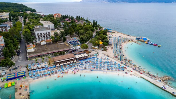 An aerial view of a coastal hotel with a beach, multiple swimming areas, and a pier with boats. - Holiday Home-big Swimming Pool-amazing Views (Kraljevica)