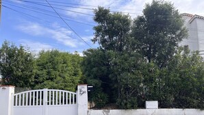 A gated property with a white fence, a mailbox, and lush greenery. - 2-room apartment near beach with garden in Saint Aygulf (Saint-Aygulf)