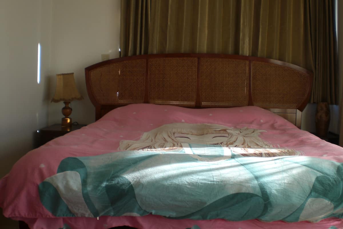 Tabla de planchar con plancha y ropa de cama