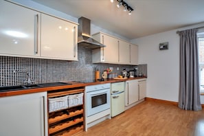Enjoy cooking in this well-equipped kitchen with an oven, dishwasher, and stainless steel range hood.