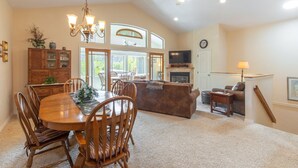 A spacious living area with a dining table, chairs, a sofa, and a television. - Unbeatable Location | Across from Ouray Hot Springs | Walk to Downtown (Ouray)