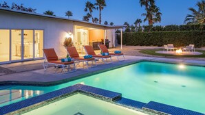 A modern house with a swimming pool, outdoor seating, and a well-lit interior. - Papillon Palm Springs – Classic Alexander Butterfly (Palm Springs)