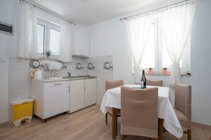 Fridge, electric kettle, cookware/dishes/utensils, spices