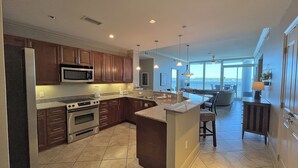 Una cocina moderna con armarios de madera oscura, electrodomésticos de acero inoxidable y una isla grande.