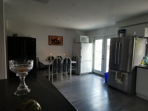 Enjoy cooking in this well-equipped kitchen with a central island, stainless steel appliances, and a dining area.
