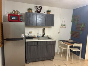 Fridge, microwave, stovetop, coffee/tea maker