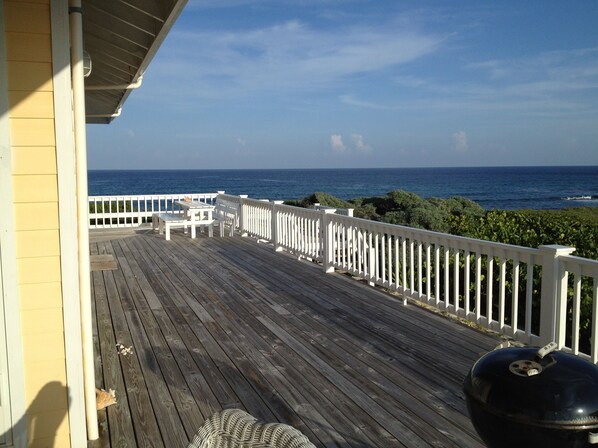A wooden deck with white railings overlooking the ocean. - Barefoot Beach - oceanfront beach house w/ private beach, sunrise & sunset views (Elbow Cay)