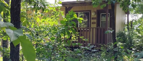 EXTERIOR:  The front of the cabin in summer.  (Note the "hillbilly chic" styling. ;-)