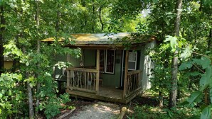 A rustic cabin with a wooden deck and a gravel path leading to the entrance. - NEW!  Village of Hope - All 6 Cabins (Ava)