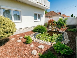 A house with a garden featuring a pond, rocks, and various plants. - Apartment Gabor by Interhome (Siofok)